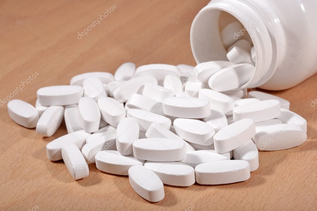 White pills spill out from bottle