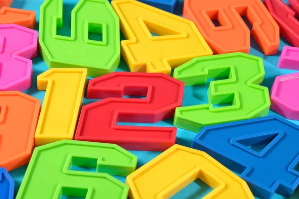 Colorful plastic numbers 123 on a blue background — Stock Photo, Image