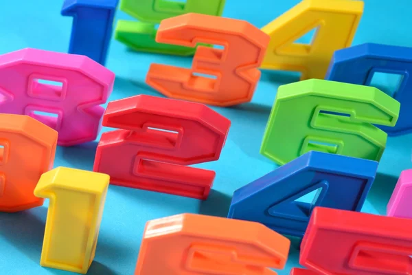 Colorful plastic numbers on a blue background — Stock Photo, Image