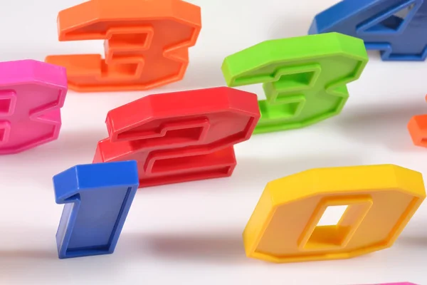 Colorful plastic numbers close up on a white — Stock Photo, Image