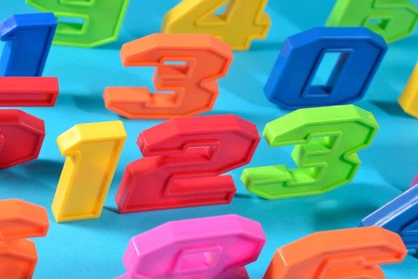 Colorful plastic numbers 123 on a blue background — Stock Photo, Image