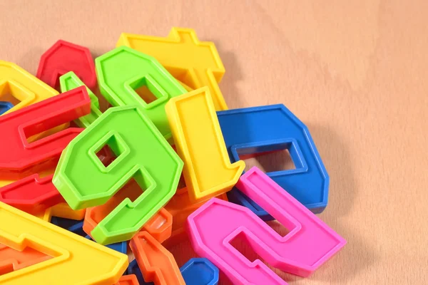 Heap of plastic colored numbers — Stock Photo, Image