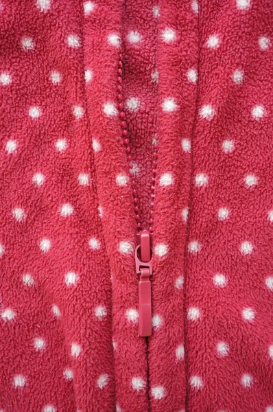 Closeup of zipper opening red fleece jacket — Stock Photo, Image