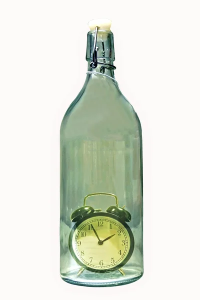 Alarm clock inside an old glass bottle — Stock Photo, Image