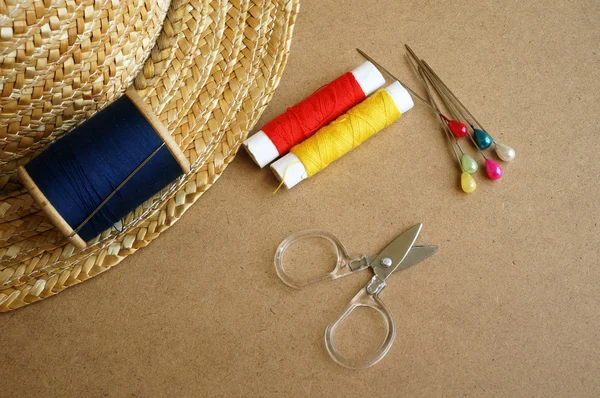 Sewing tools scissors, bobbins with thread and needles on wooden background — Stock Photo, Image