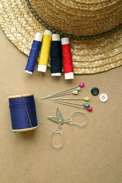 Old style image of cotton reels and other sewing items on a wooden table — Stock Photo, Image