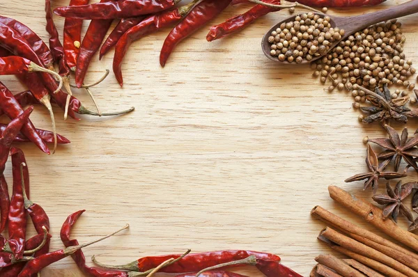 Spices and herbs frame on a wooden background — Stock Photo, Image