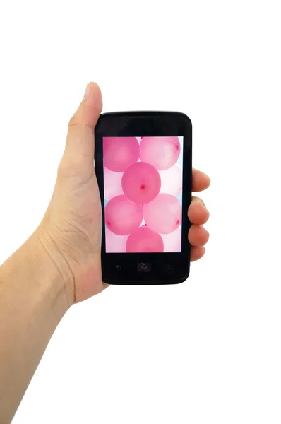 Telefon komórkowy w ręku różowy balon na białym tle — Zdjęcie stockowe