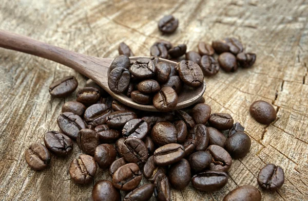 Coffee beans on an old wooden background Royalty Free Stock Photos