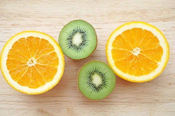 Fruitige achtergrond set segmenten van oranje groenten en kiwi — Stockfoto