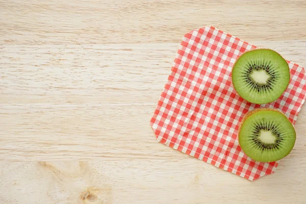 Ripe kiwi on wooden table — Stock Photo, Image