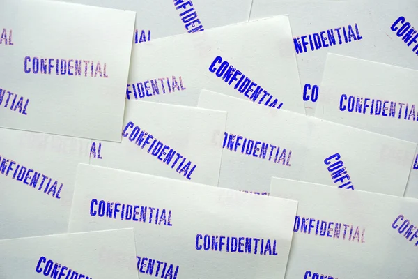 Blue stamped confidential on white memo papers — Stock Photo, Image