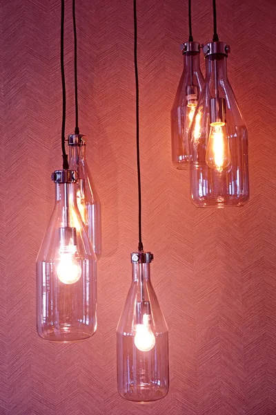 Hanging light bulbs, on red background. — Stock Photo, Image