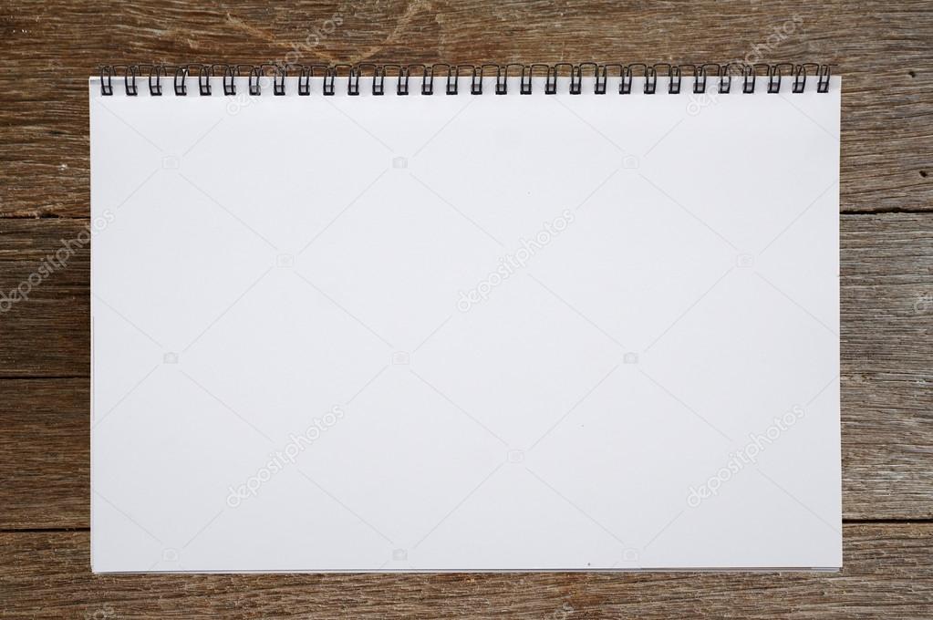 Open sketchbook or notebook on wooden background