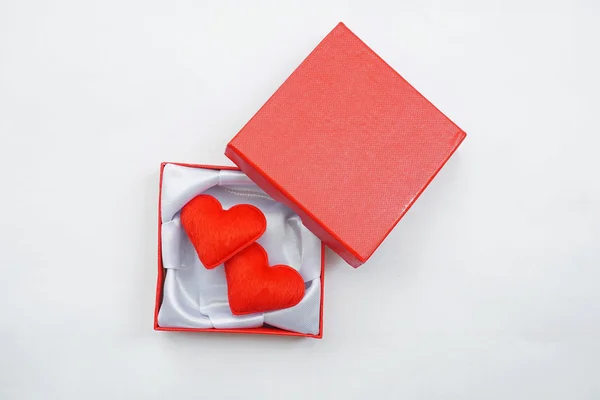 Red gift box with red hearts inside on white background — Stock Photo, Image