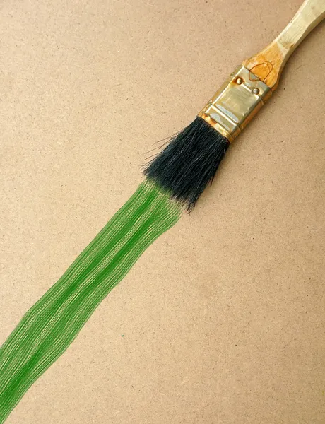 Brush painting on wooden background — Stock Photo, Image