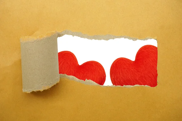 Red heart under torn paper strip — Stock Photo, Image