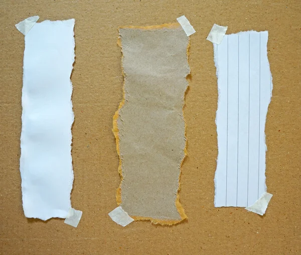 Torn Paper Scraps On Cardboard Wall — Stock Photo, Image