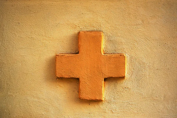 Πορτοκαλί σταυρό σε ένα τοίχο πορτοκαλί Σταυρός σε έναν τοίχο — Φωτογραφία Αρχείου