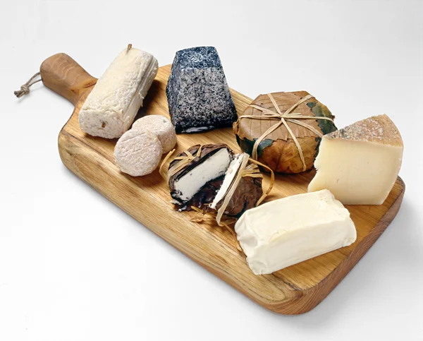 Wooden board with cheese assortment — Stock Photo, Image