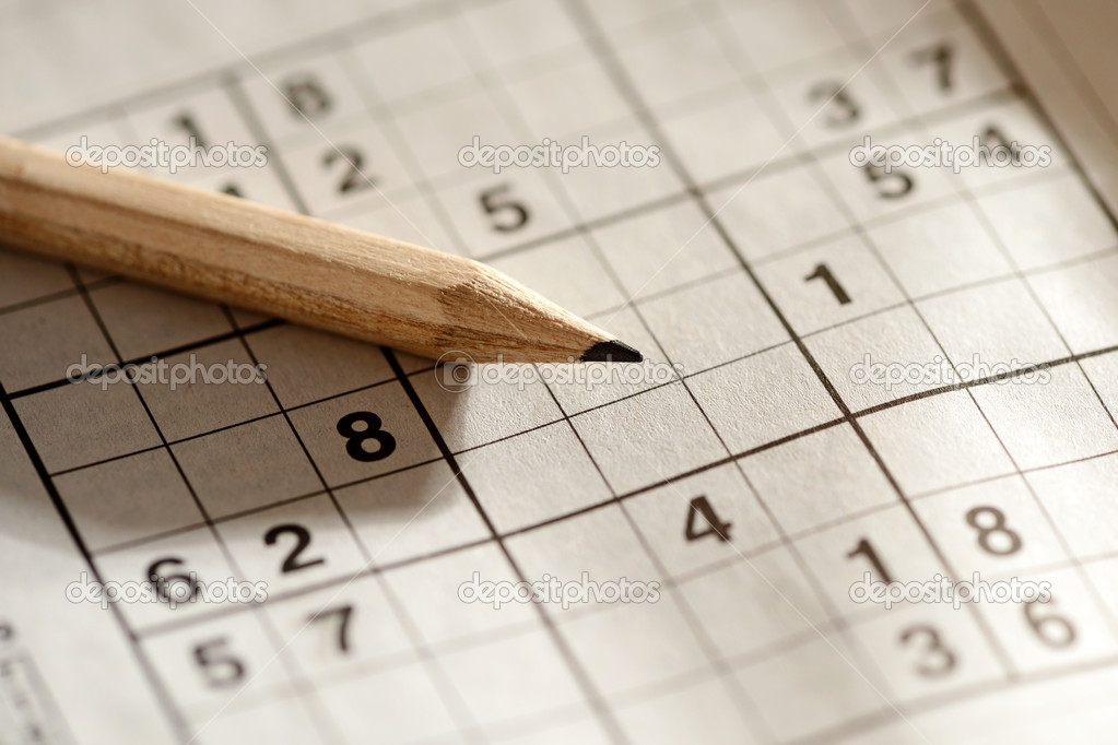 Pencil lying on a sudoku grid