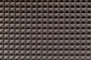 Prova odasında geometrik desenli kahverengi ses emici duvarın desenli tam çerçeve arka planı