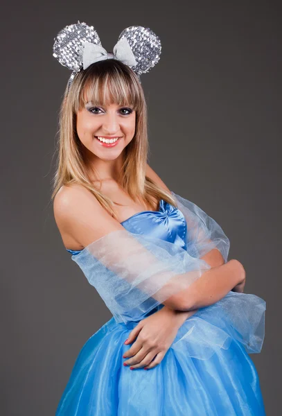 Hermosa chica en un vestido azul con orejas de ratón festivo —  Fotos de Stock