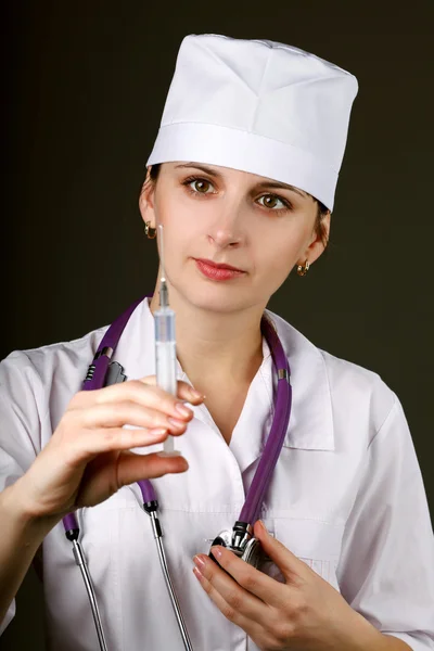 Woman doctor with syringe in hand — Stock Photo, Image