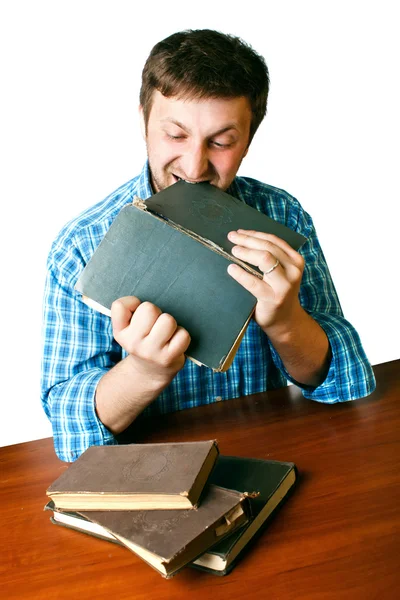 Man with anger biting book — Stock Photo, Image