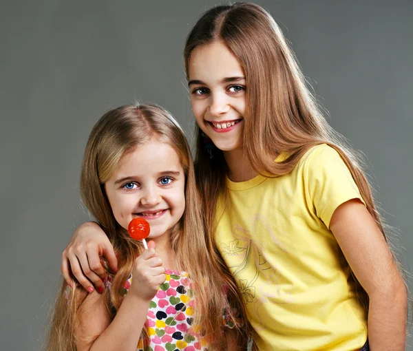 Two girls with candy — Stock Photo, Image