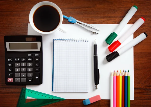 Desk with sheet of paper and stationery objects — Stock Photo, Image