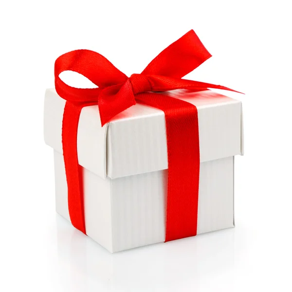 White gift box with red ribbon Royalty Free Stock Photos