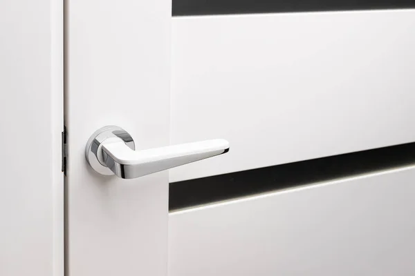 Door handles elements close up. Door handle on white closed doors in modern loft style in interior. Concept of accessories for interior design home interior of apartment or office.