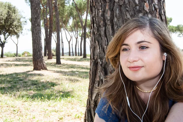 Pretty Girl escucha música en el prado — Foto de Stock