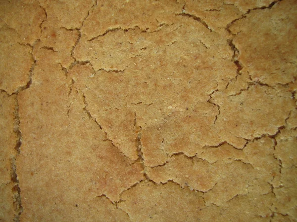 Gebarsten oppervlak - korst van maïs brood achtergrond — Stockfoto
