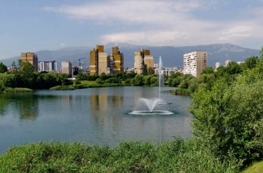 Spring panorama of a part of a residential area with a lake and a fountain,  Drujba, Sofia, Bulgaria 