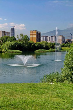 Spring panorama of a part of a residential area with a lake and a fountain,  Drujba, Sofia, Bulgaria 