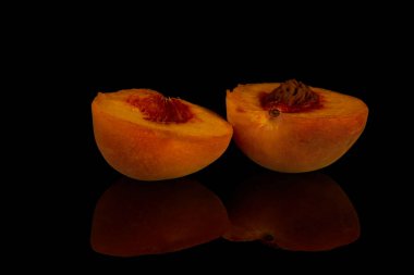 yellow peaches lie on a black background, fruit