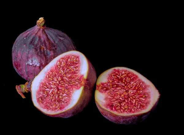 fig fruits lie on a dark background, vitamins