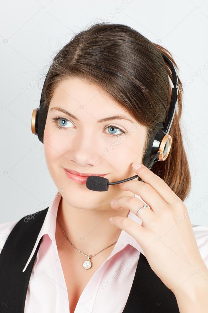 Manager a girl with headsets and microphone speaks with a client