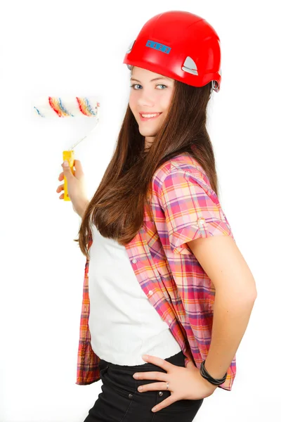 А girl in a building helmet with a painter roller in a hand — Stock Photo, Image