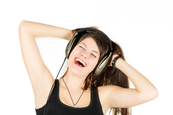 A portrait of girl is in a sportswear that sings and listens music in headsets