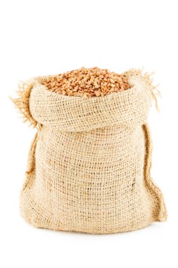 A sack is linen filled by buckwheat groats clipart
