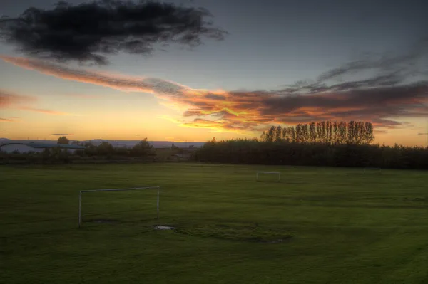 Zonsondergang over voetbalveld — Stockfoto