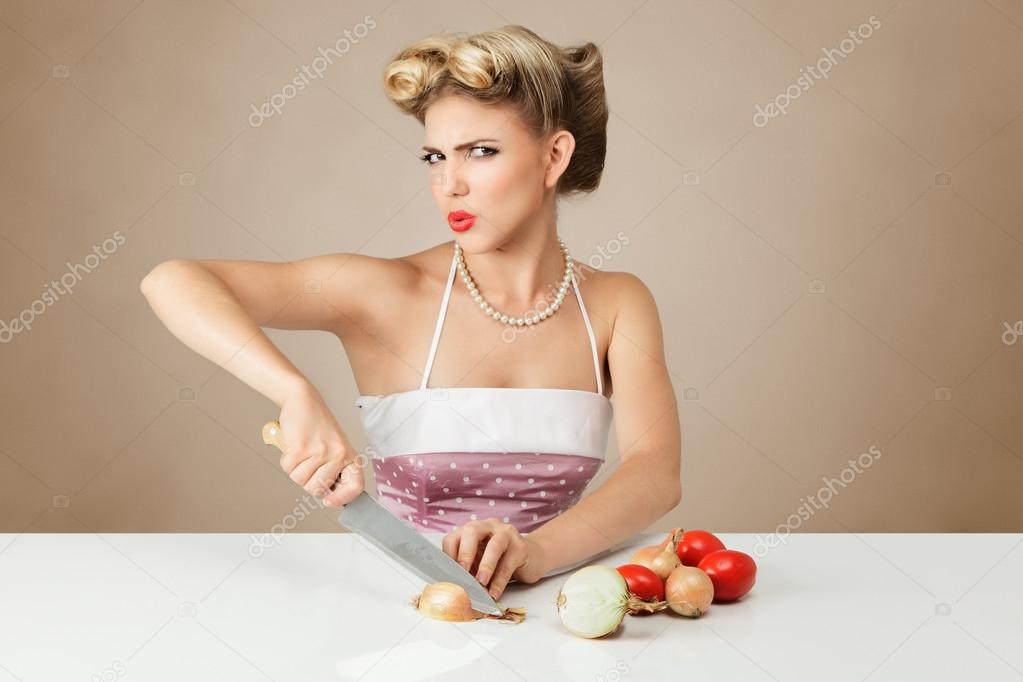 Young woman cutting onion