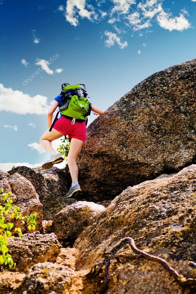 Woman climbs over a rock — Stock Photo © Semion888 14336751