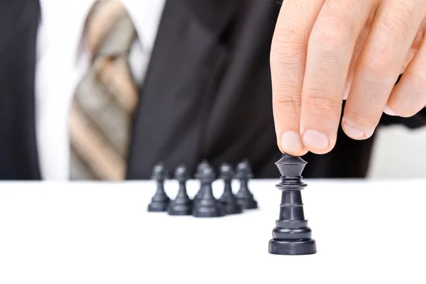 Businessman moves chess king figure — Stock Photo, Image