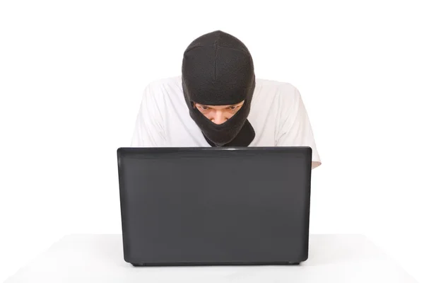 Man in black mask looking at monitor — Stock Photo, Image