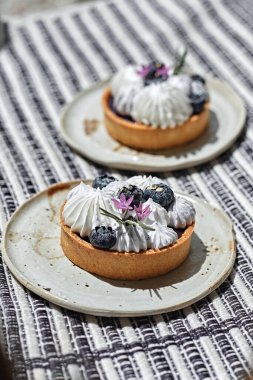 Homemade mini tart with blueberries and whipped crea