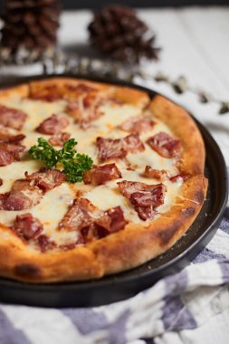 Homemade bacon and cheese pizza on the table